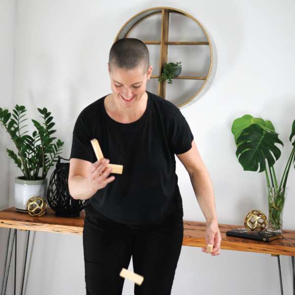 yvette balancing wood blocks that are falling